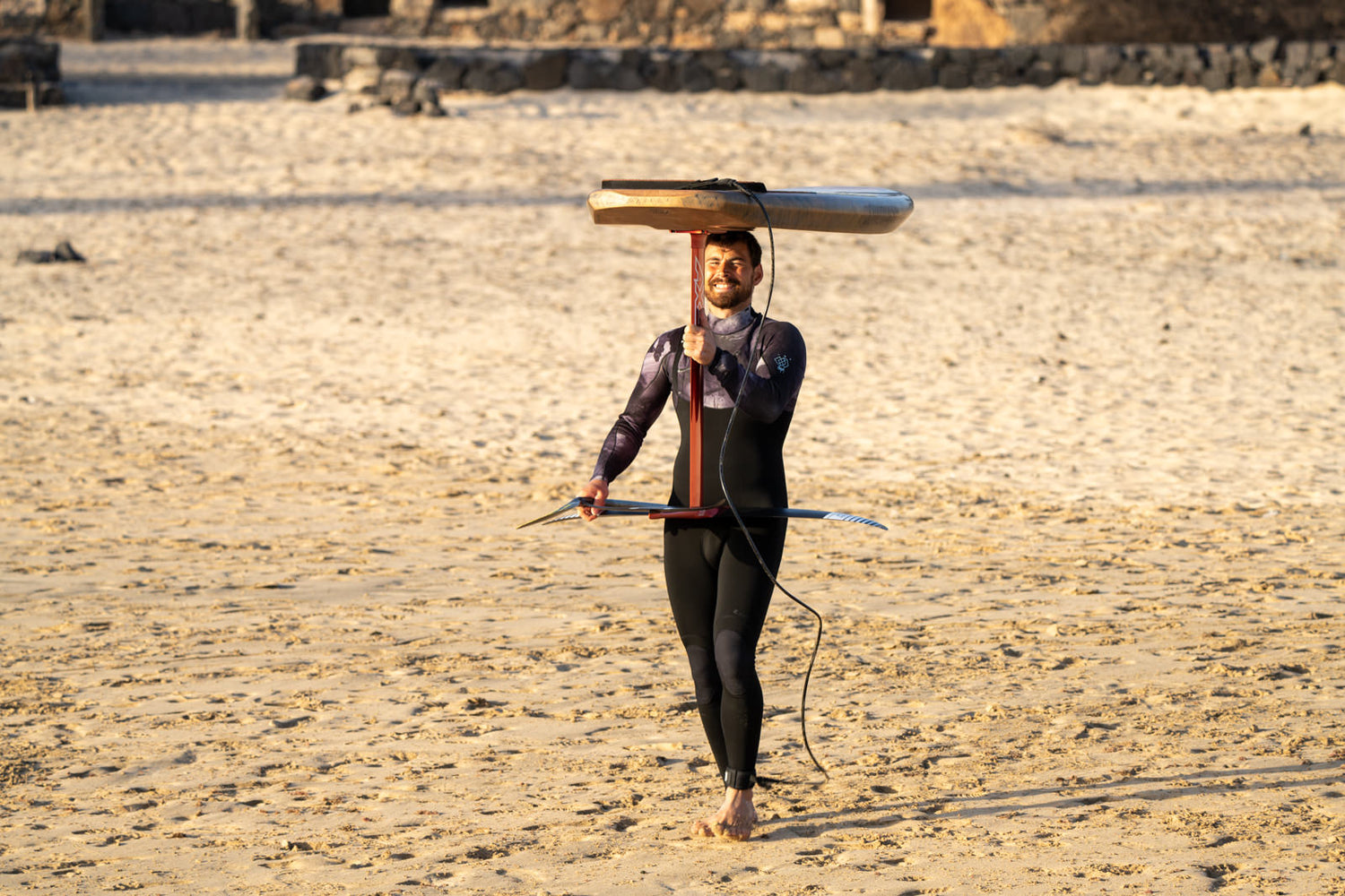 Kai-Nicolas Steimer auf dem Weg zum Surfen mit Sunova SUP Foil Board auf dem Kopf.